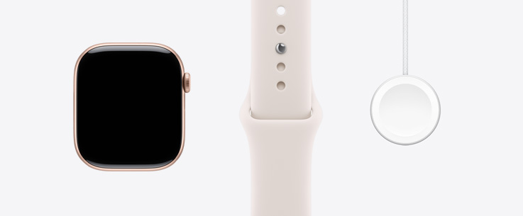 Apple Watch Series 11, hliníkové pouzdro, růžově zlatá barva, pohled zepředu, displej od okraje k okraji, světle ruměný sportovní řemínek, magnetická rychlonabíječka Apple Watch s USB‑C kabelem