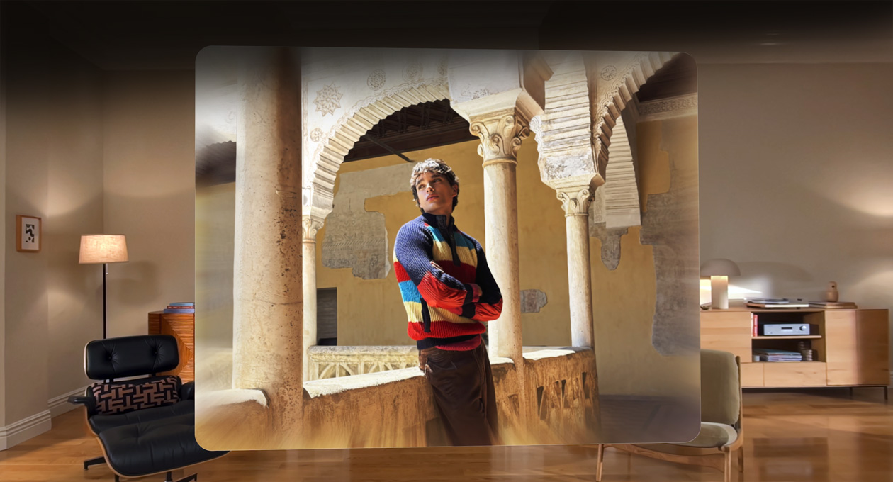 Spatial scene in a photo of a man leaning against a balcony in a winding courtyard, with depth and dimension in the surroundings